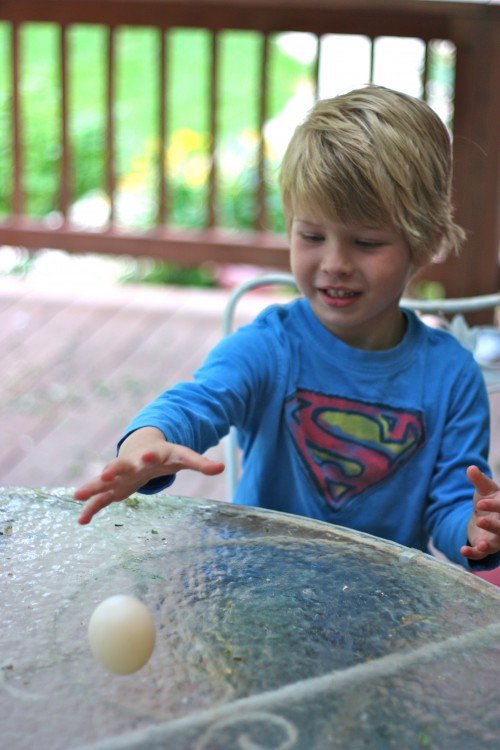 Child bouncing an egg