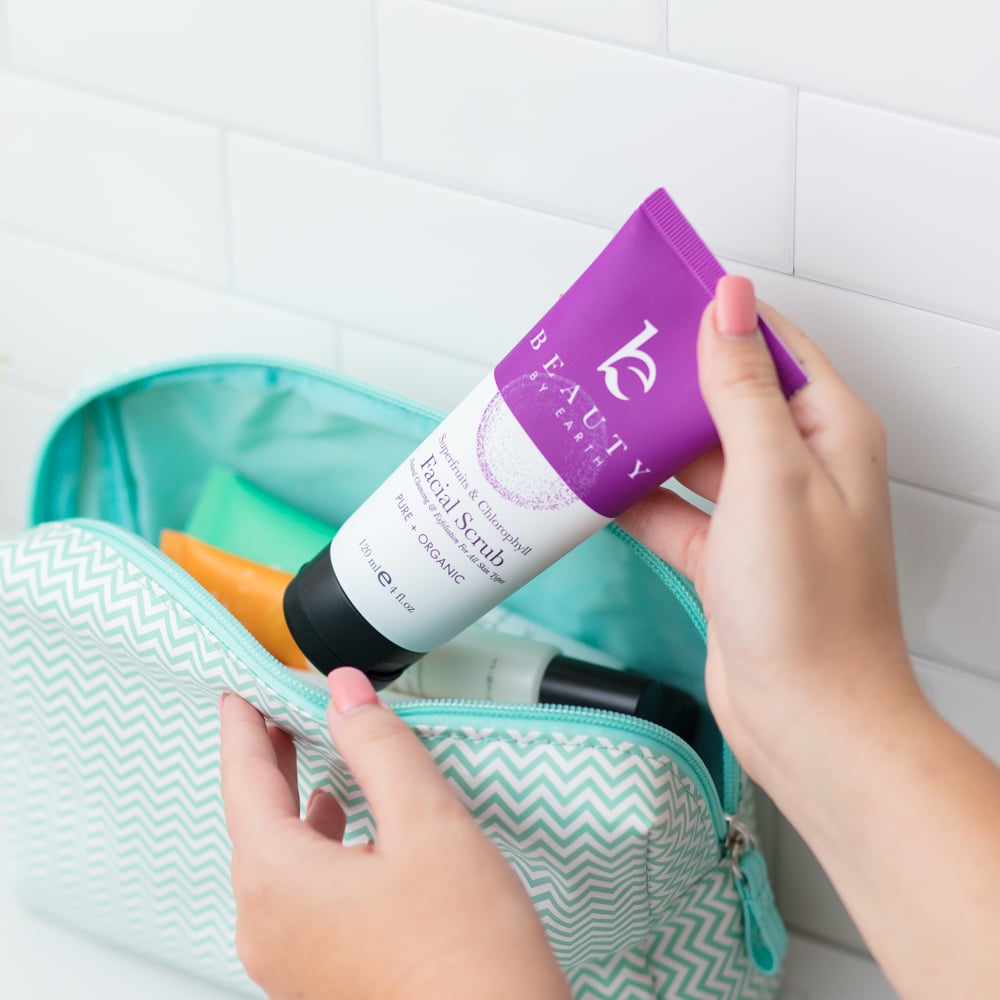 Person putting Beauty by Earth facial scrub into a bag