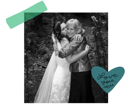 A bride and mom hugging each other