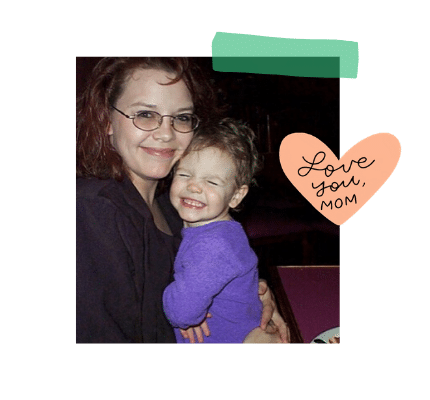 A woman holding her baby girl and smiling