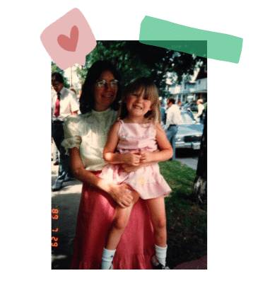 A woman holding her daughter for a photo