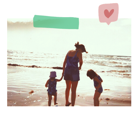 A mom with two young daughters on a beach